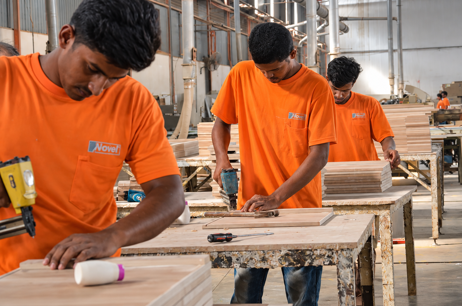 Novel Interior team members crafting furniture in the workshop