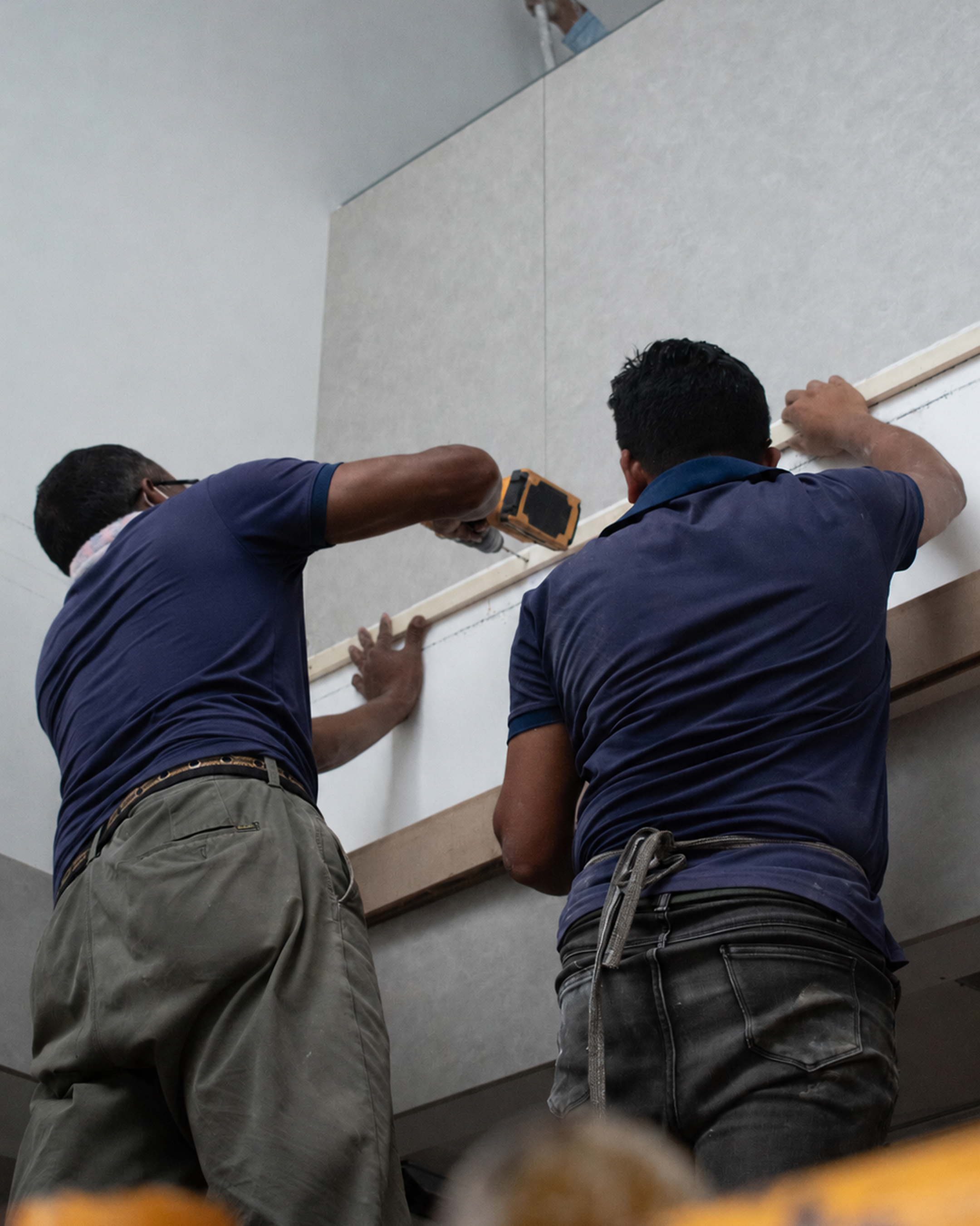 Novel Interior team installing wall panels on site